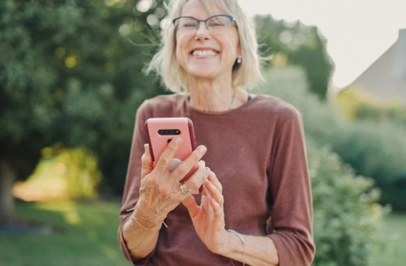 mature women laughing and drinking tea